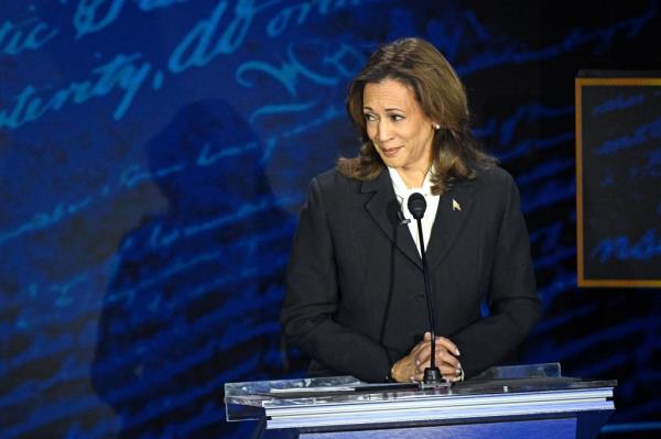 Kamala Harris, US Vice President and Democratic presidential candidate, attentively listening to former US President Donald Trump during a debate.